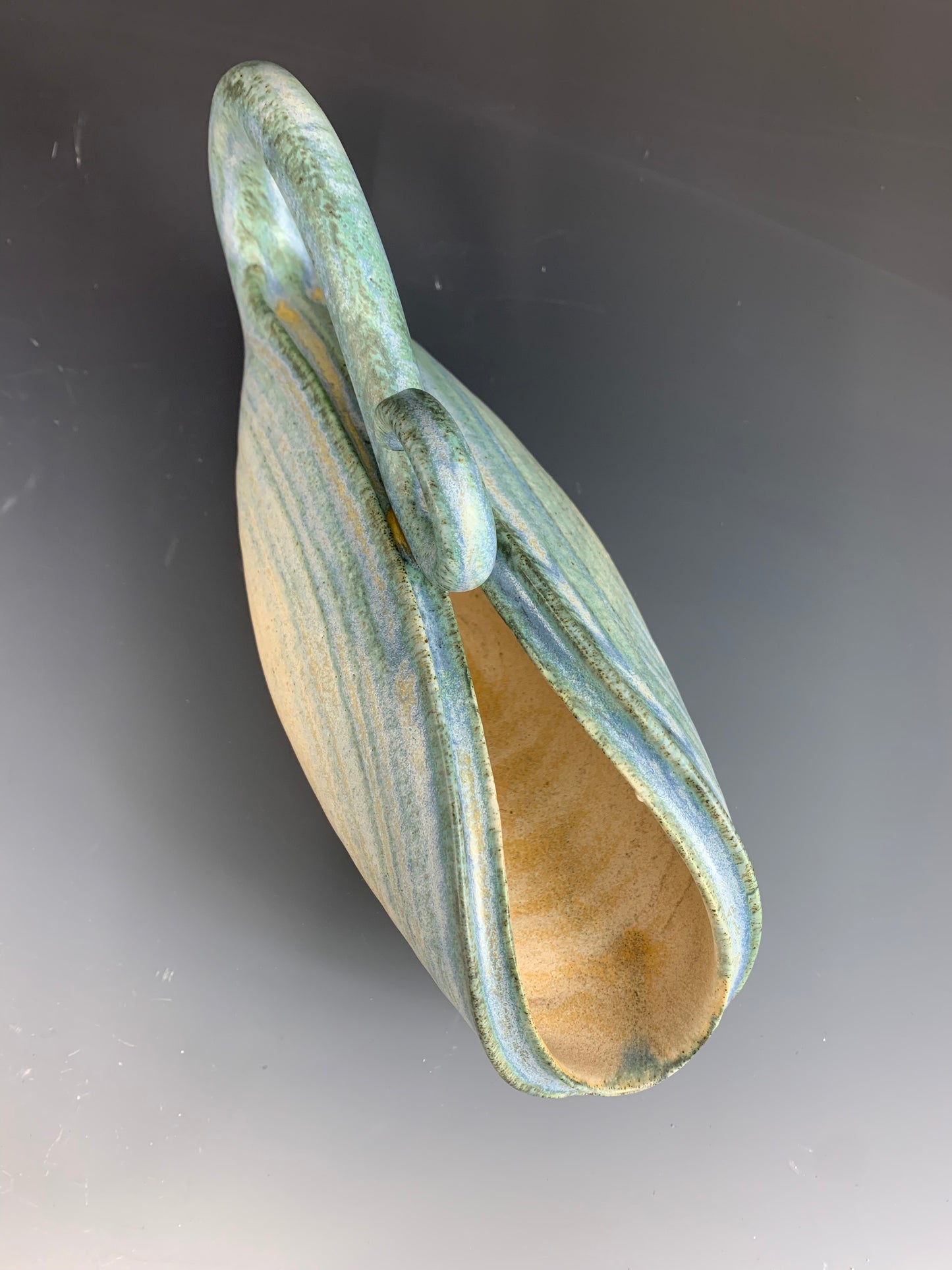 Above view of handmade yellow and green watering can for plants