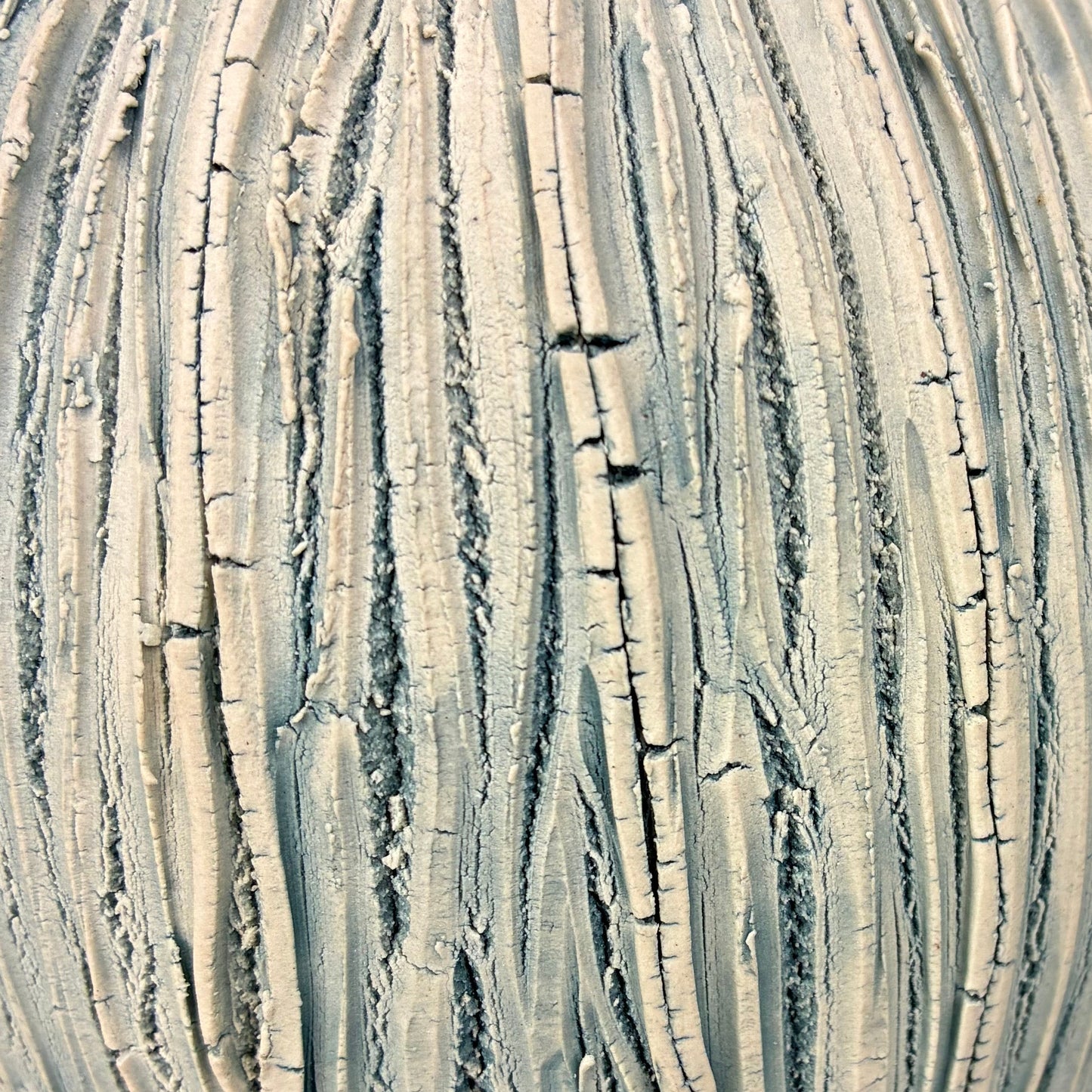 Textured greenish-brown object on a dark background