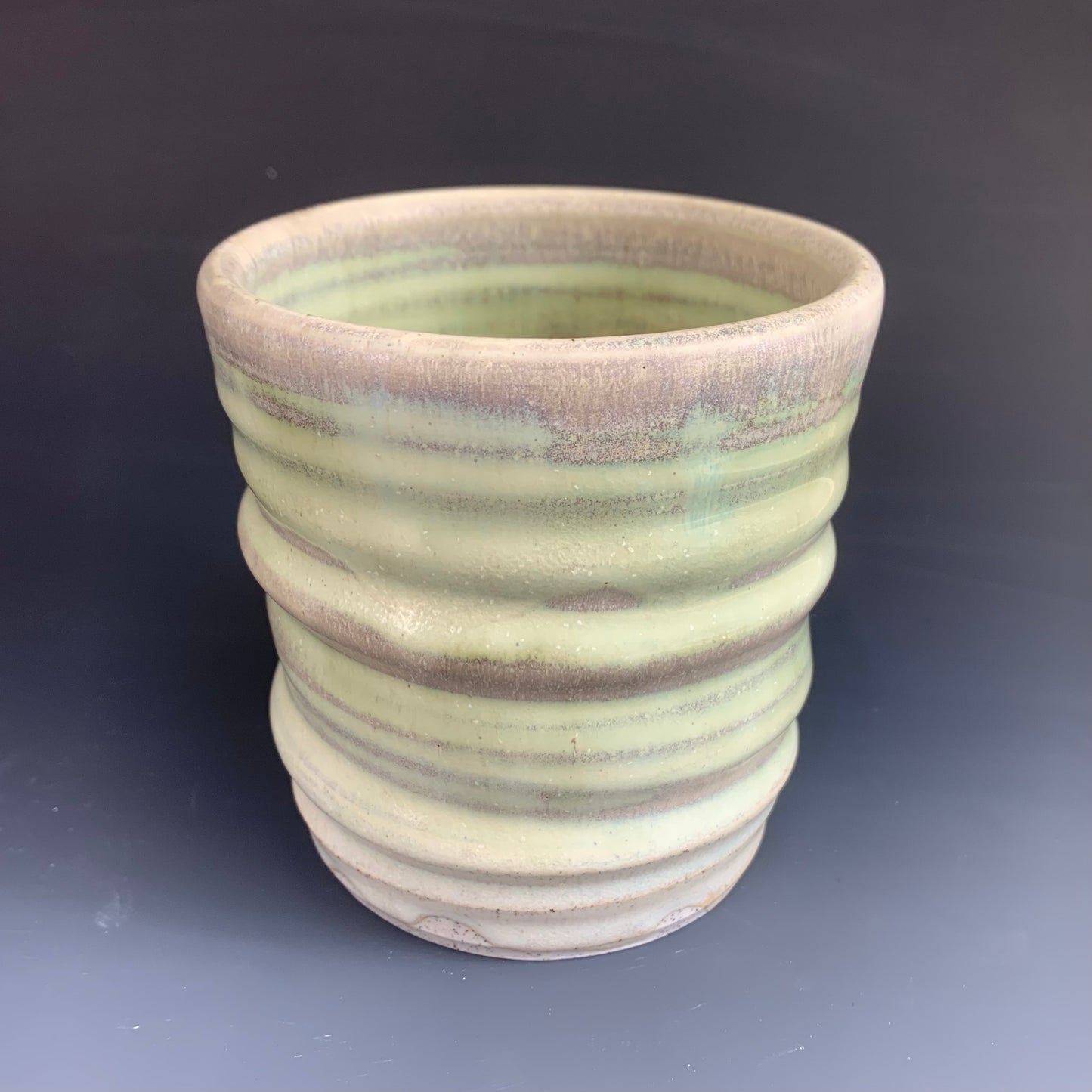 Green and Gray Wheel thrown cup on dark background