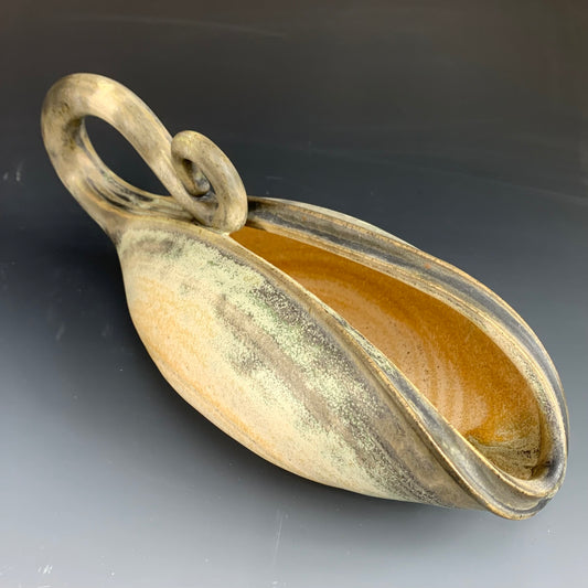 Side view of handmade yellow and green watering can for plants