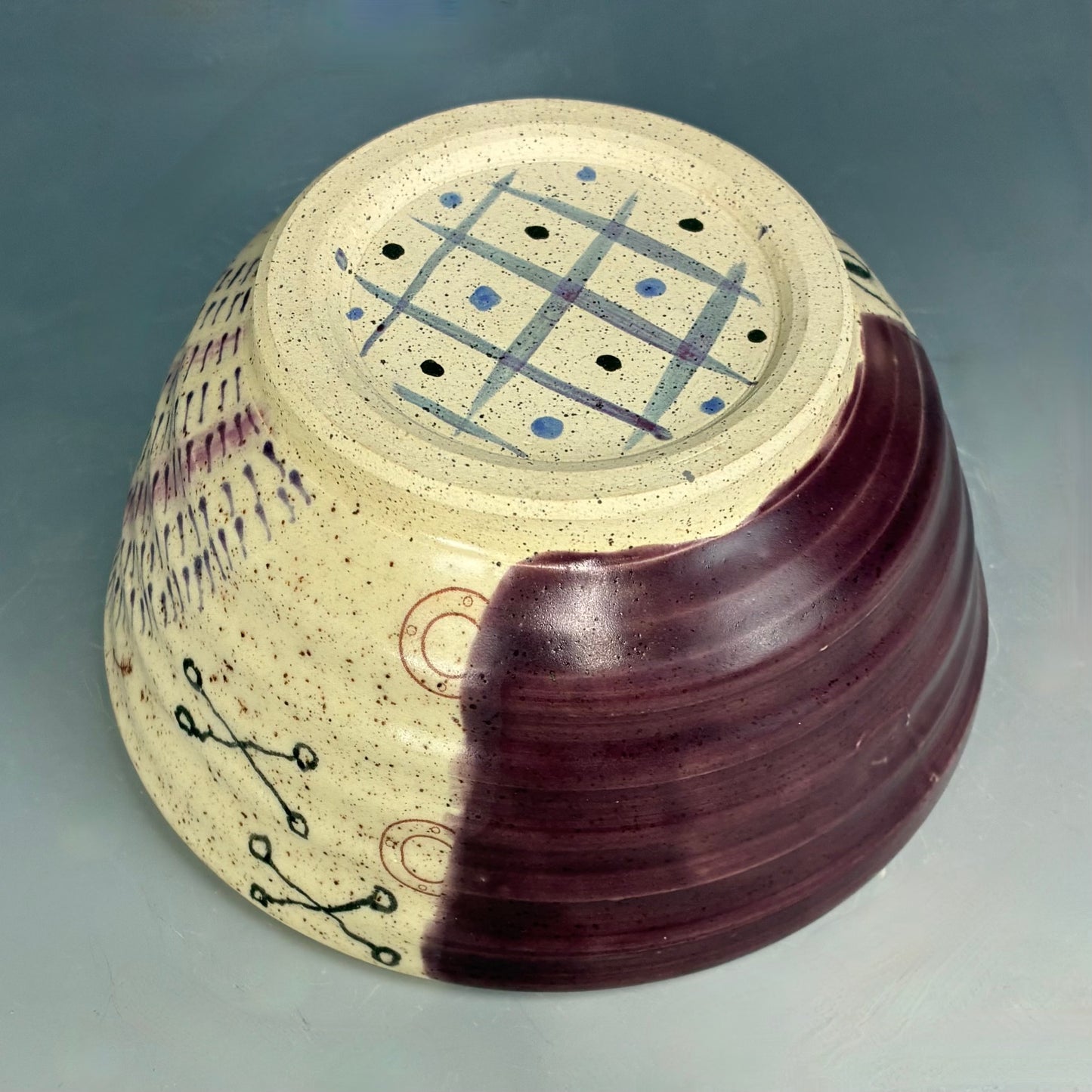 Ceramic bowl with decorative patterns on a gray background