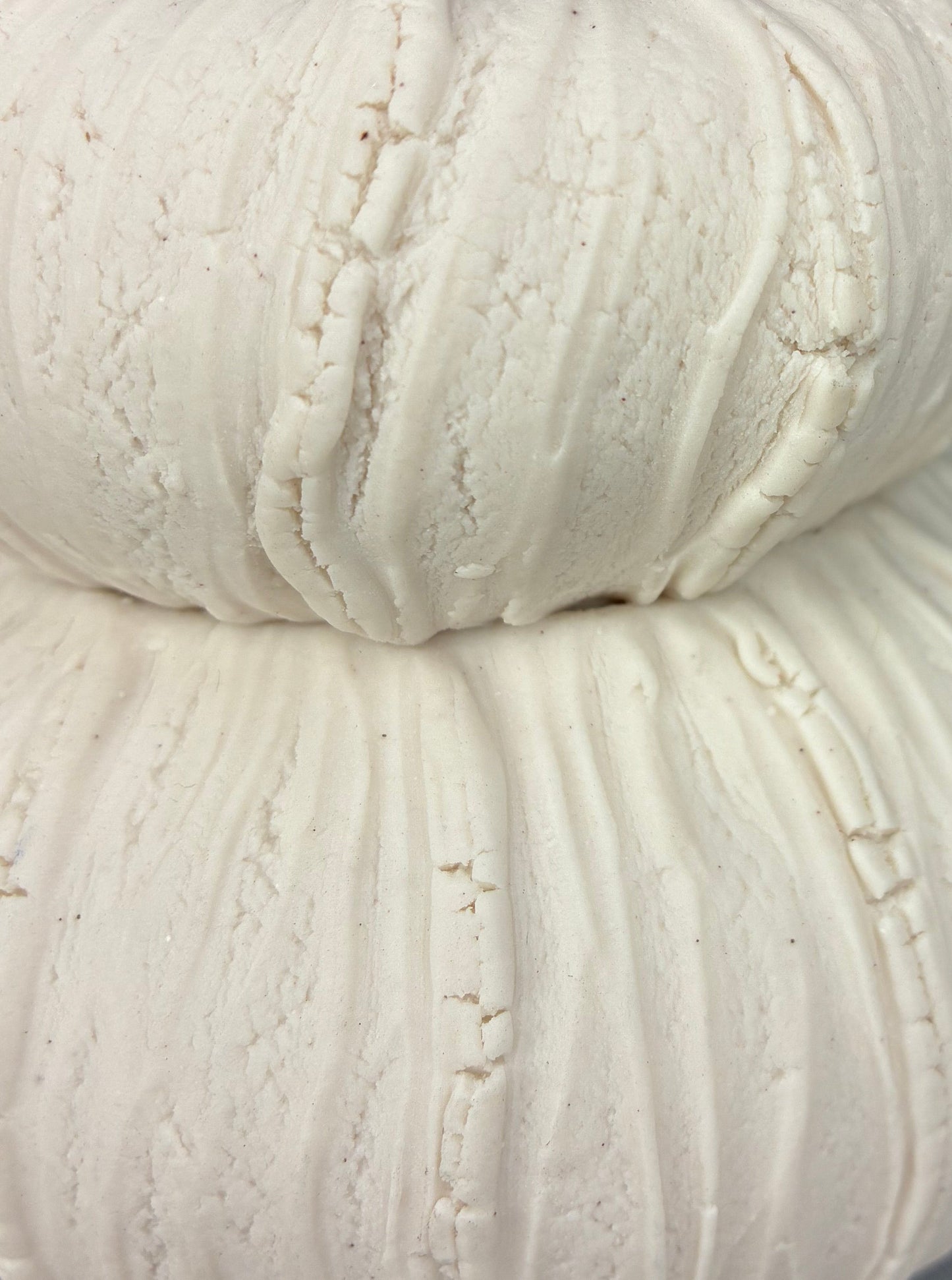 Close-up of a ball of white porcelain on a dark background