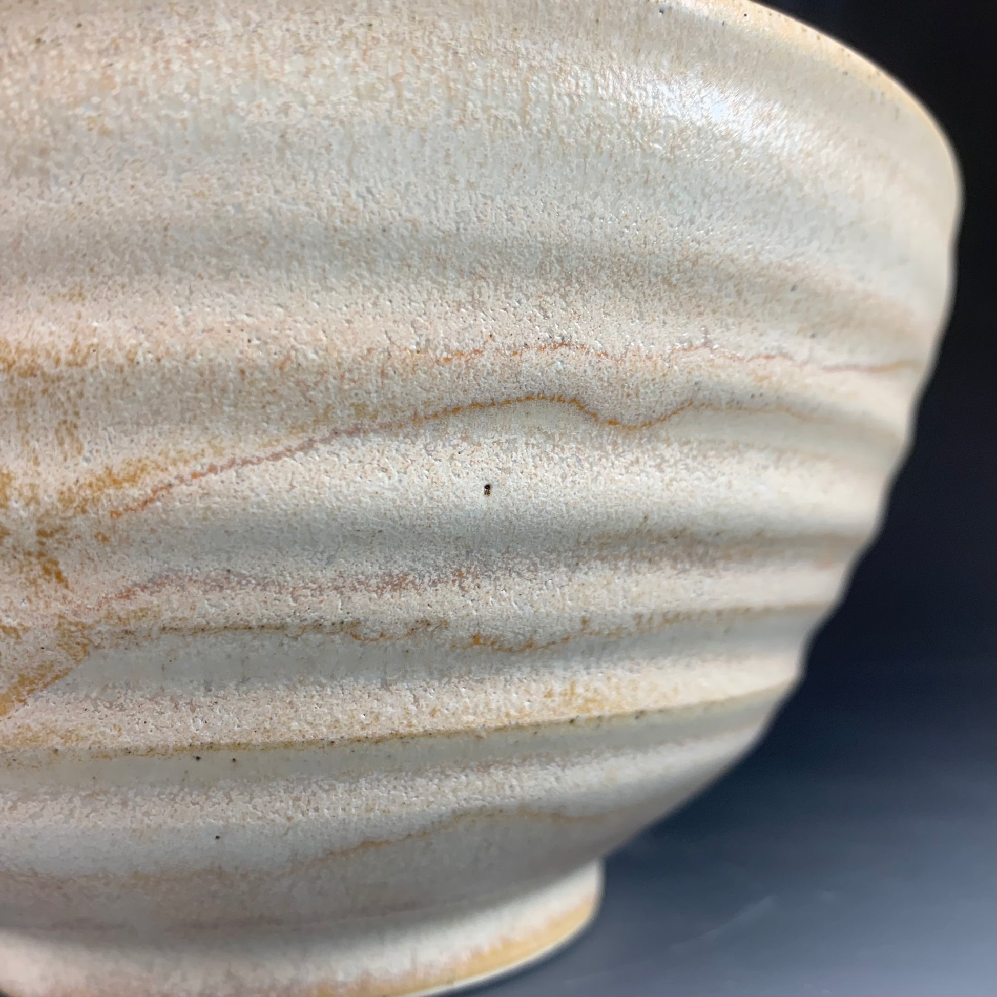 Detail of Yellow Ramen Bowl on Dark Background