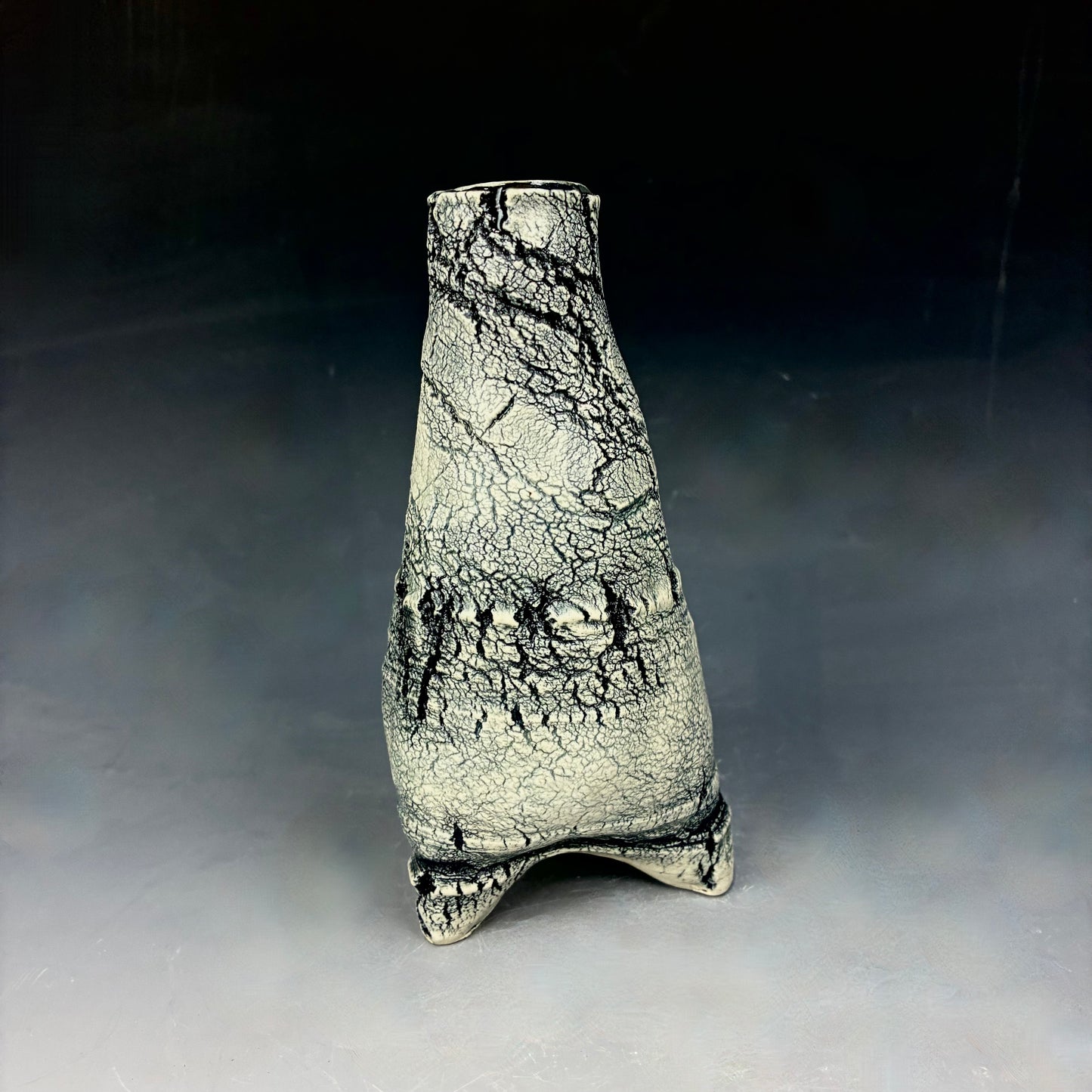 Ceramic vase with textured surface on a gray background