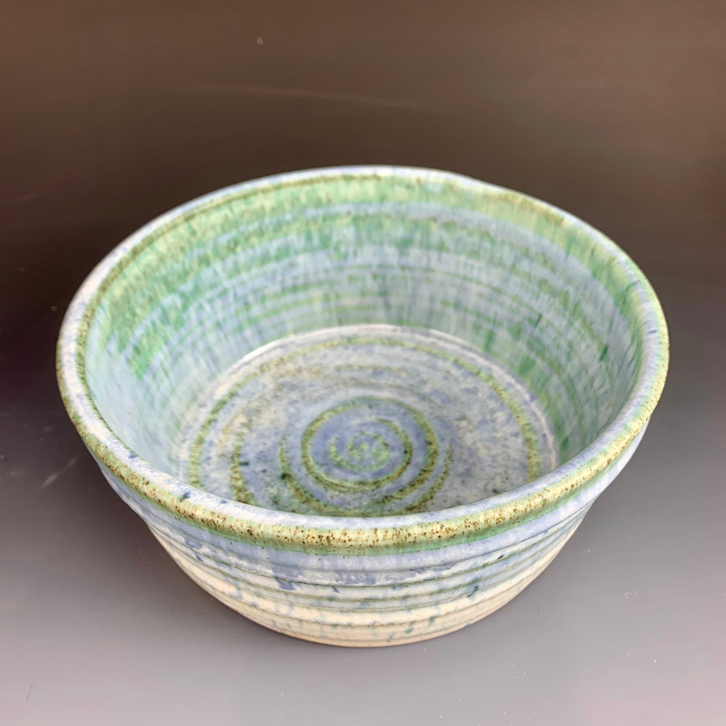 Above view of Blue and White Wheel thrown bowl on dark background