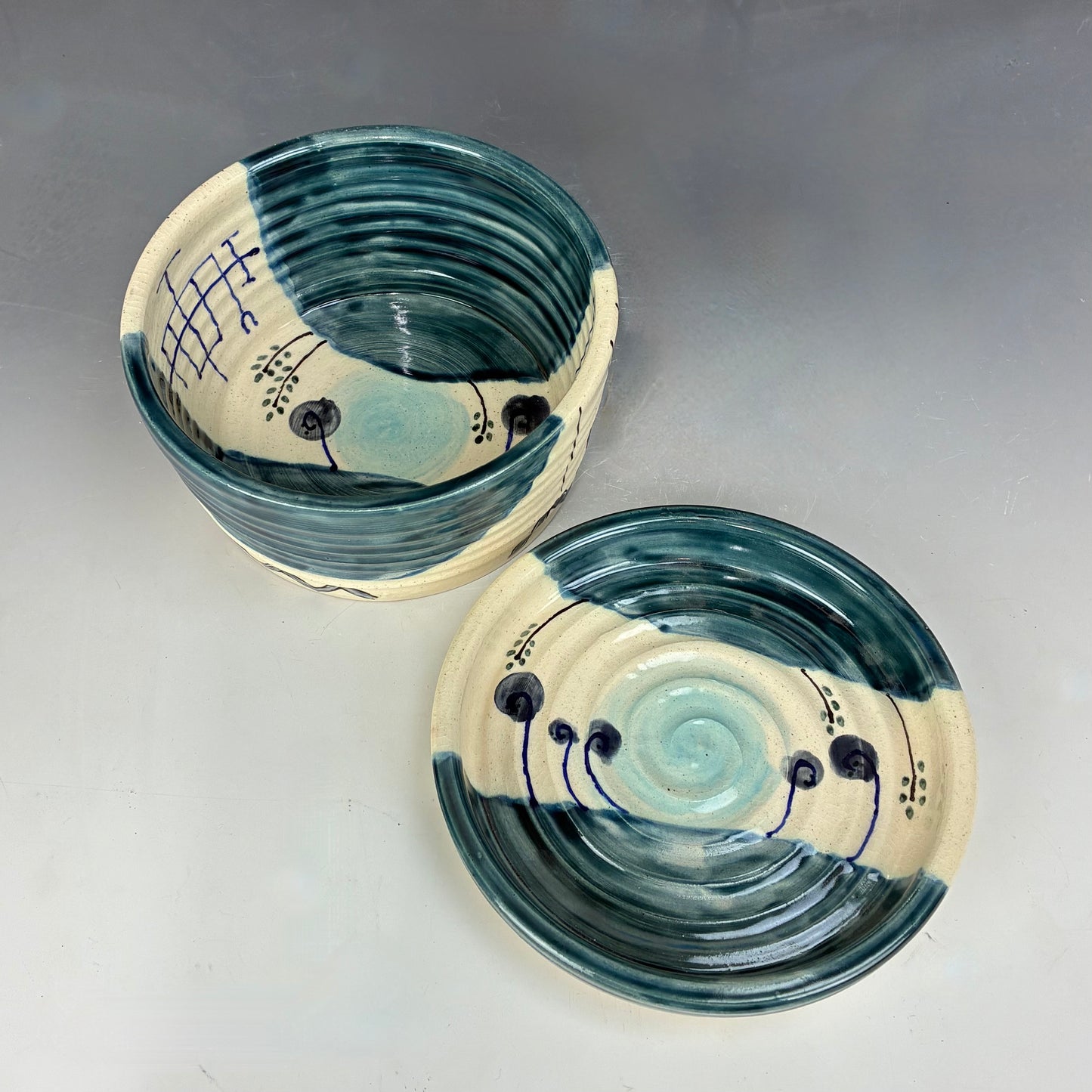 Two ceramic bowls with blue and white design on a gray background