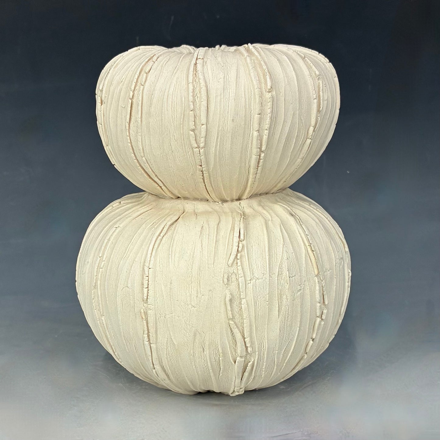 White textured vase on a gray background