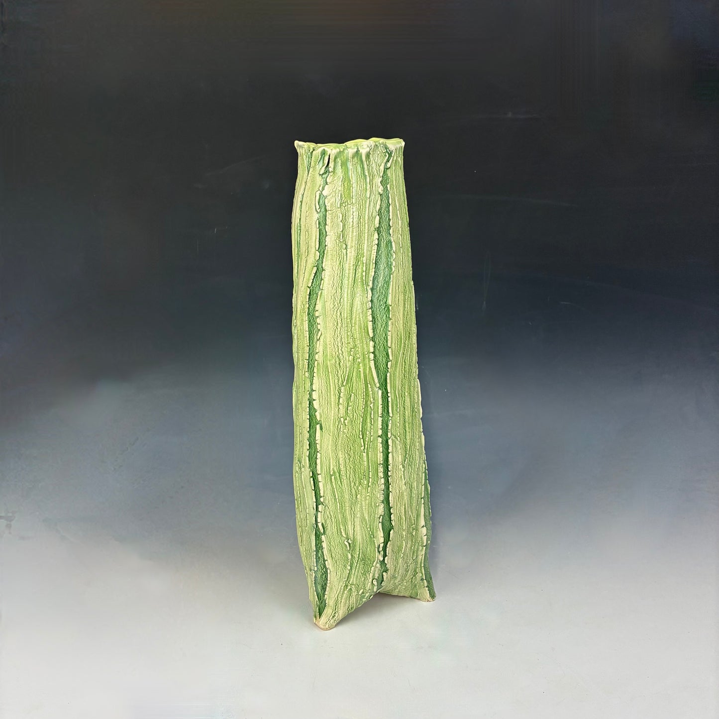 Green textured vase on a gradient background
