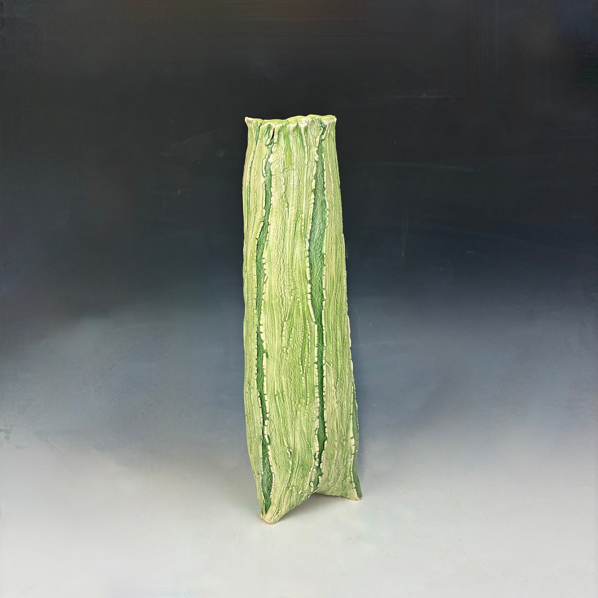 Green textured vase on a gradient background
