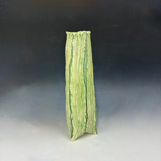 Green textured vase on a gradient background