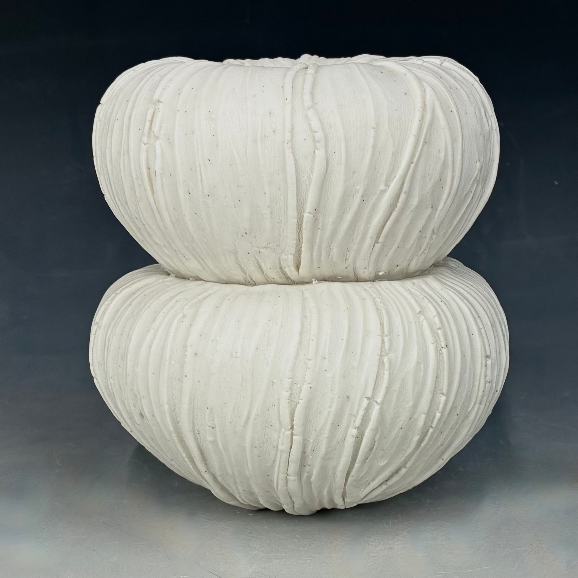  textured white ceramic Vase on a dark background