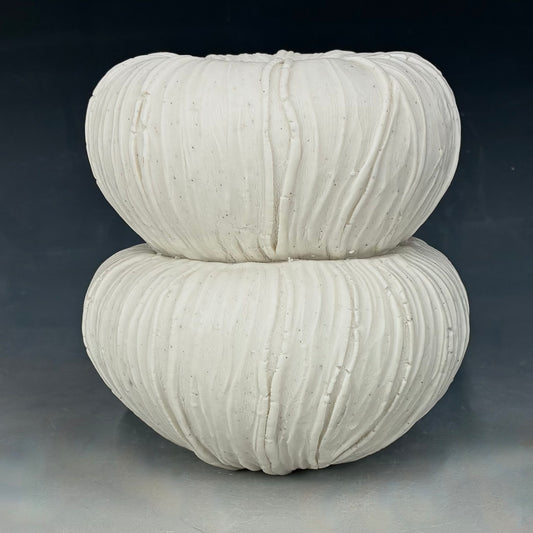  textured white ceramic Vase on a dark background