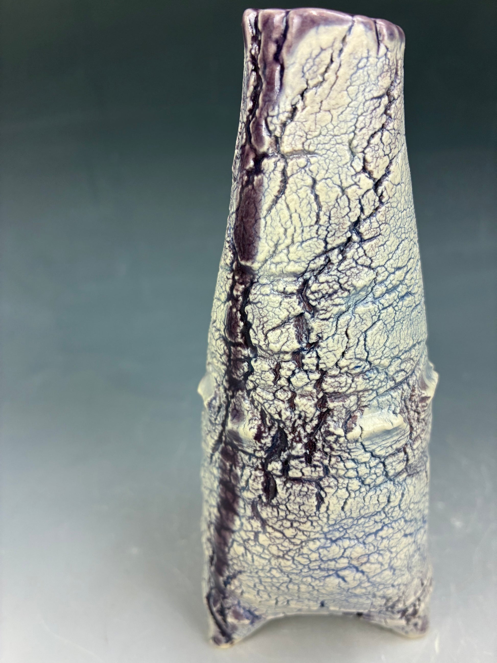 Cracked surface ceramic piece on a gray background