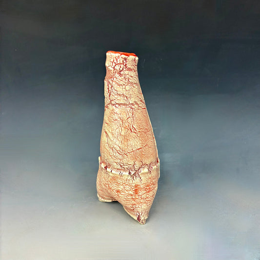 Textured ceramic red and white vase on a gradient gray background