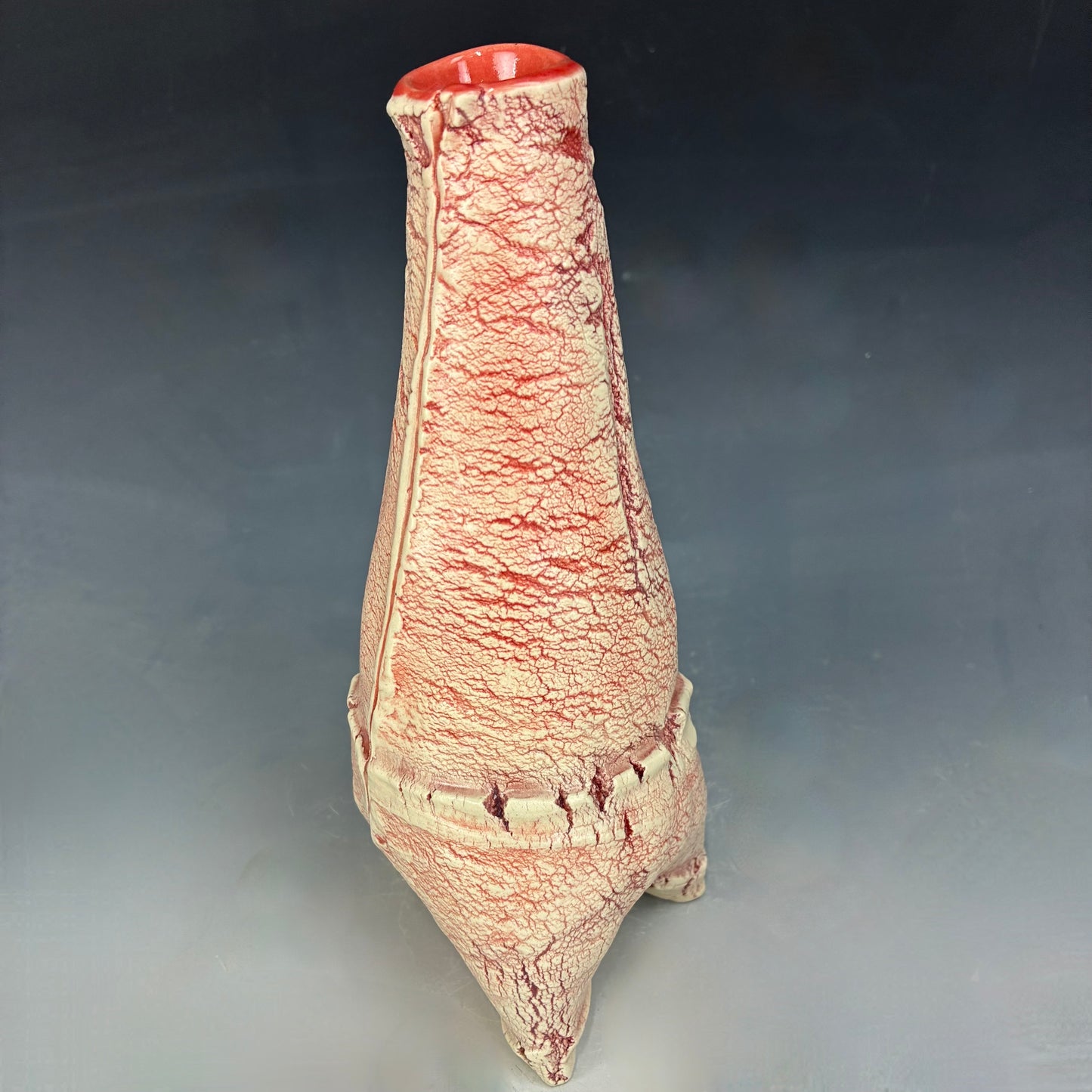 Textured ceramic vase on a gradient gray background