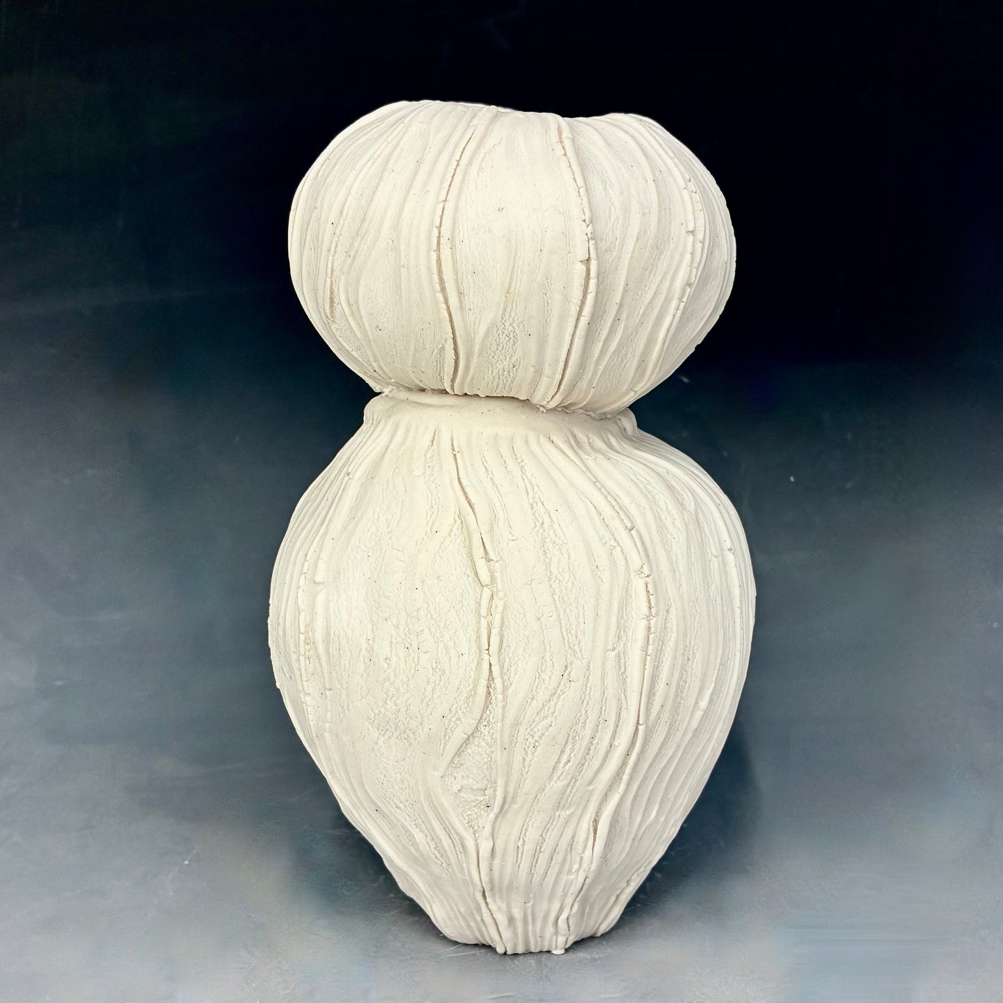 White textured vase on a dark background