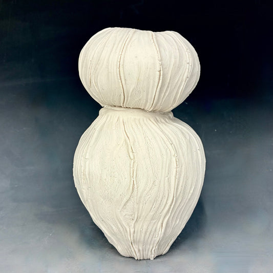 White textured vase on a dark background