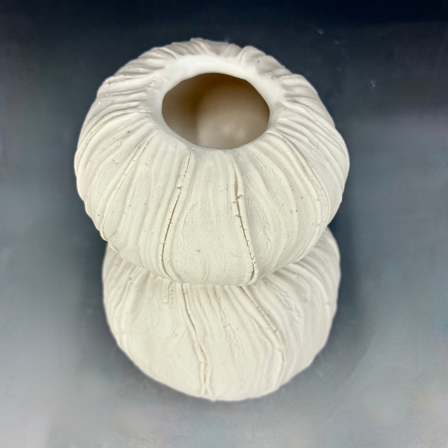 White textured vase on a gray background