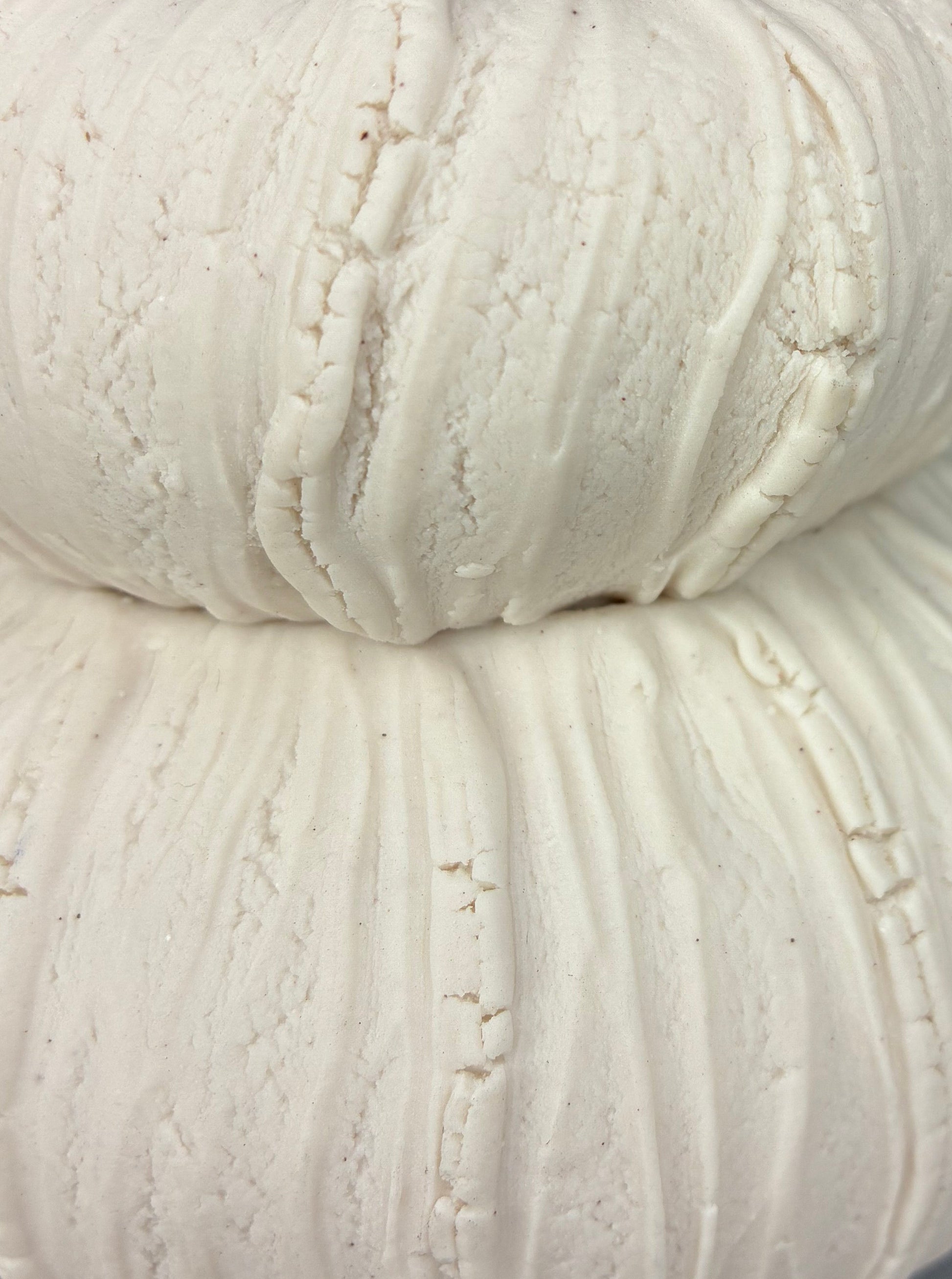 Close-up of a ball of white porcelain on a dark background