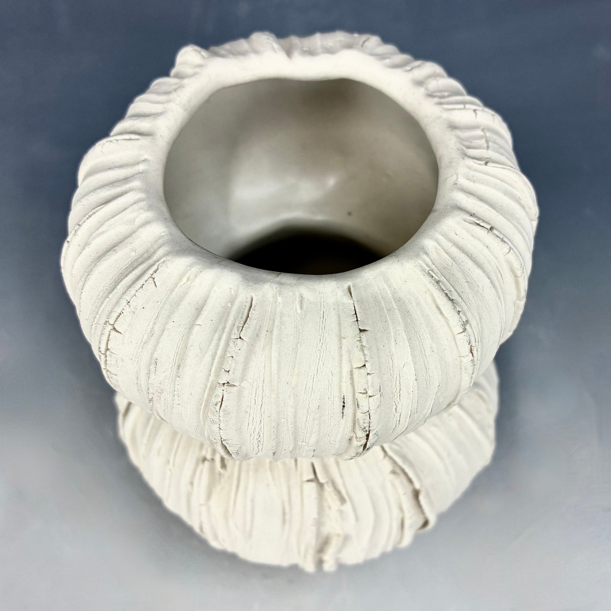 Top view of Textured ceramic vase on a gray background