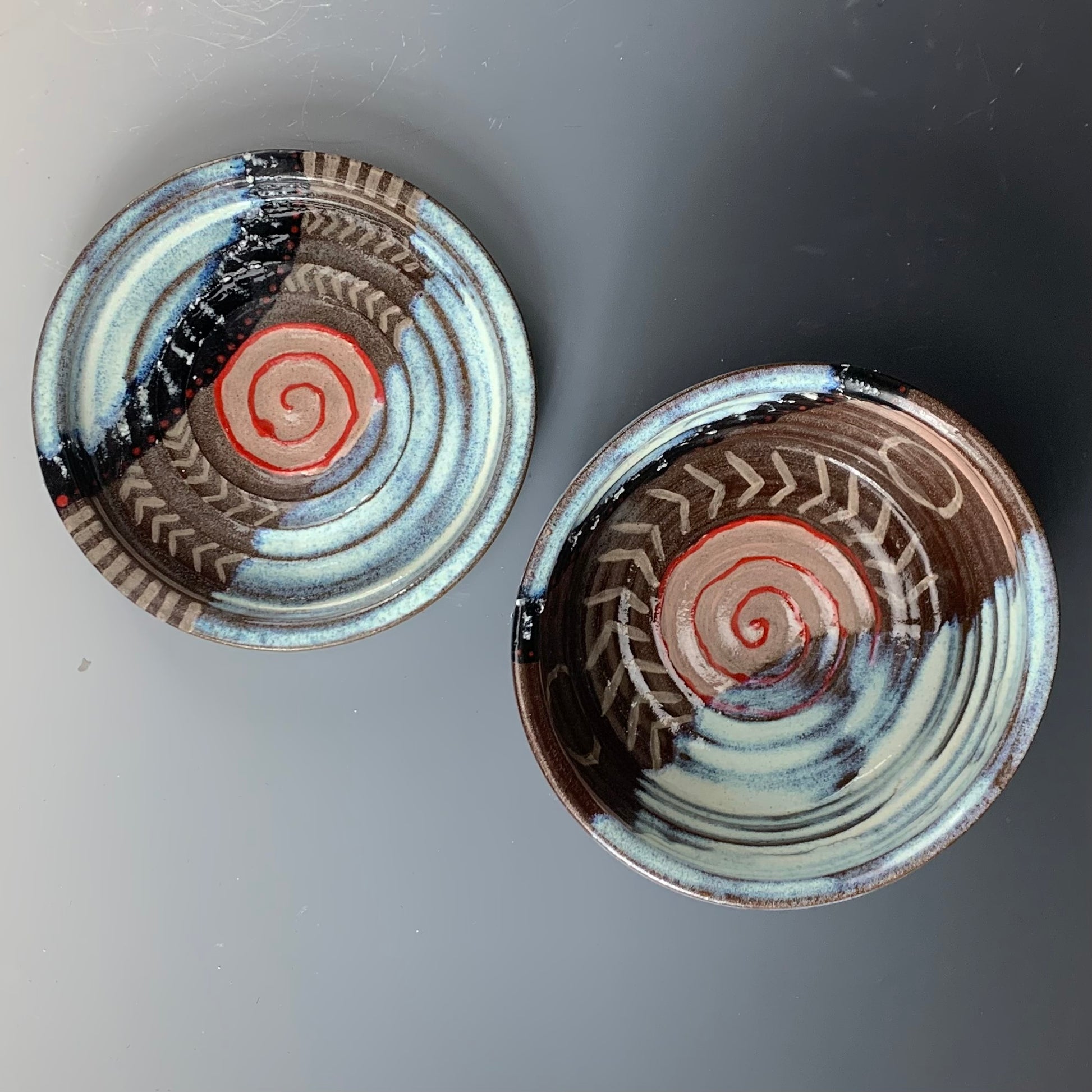 Above view of Brown, White, Black and Red decorated ceramic storage container, Lid off