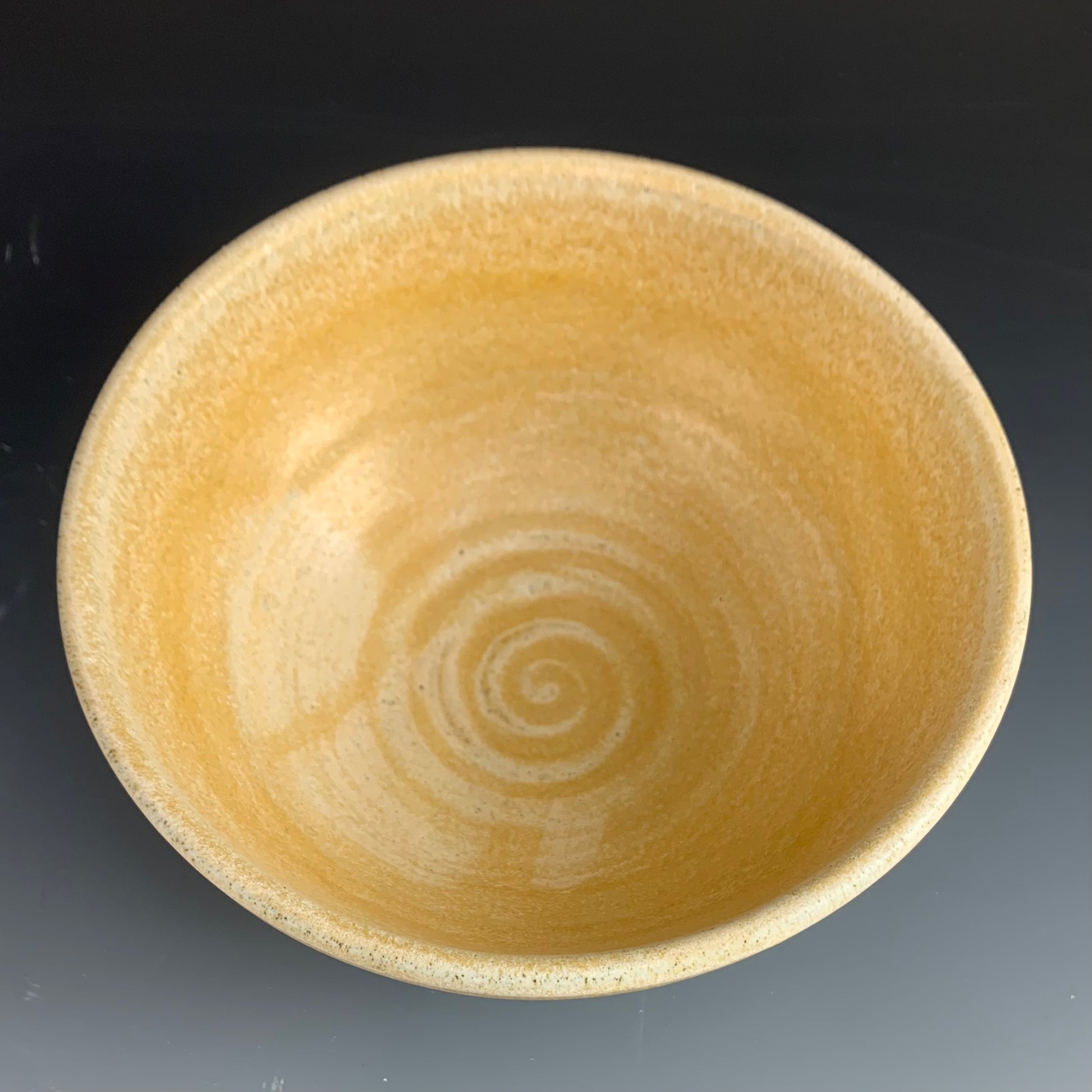 Above View of Yellow Ramen Bowl on Dark Background